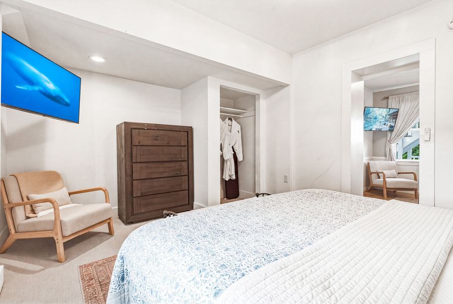 Room 10 king bedroom with dresser, television, and adjoining suite