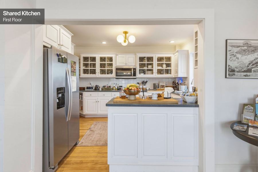 Bright kitchen with white cabinets, modern appliances, and island