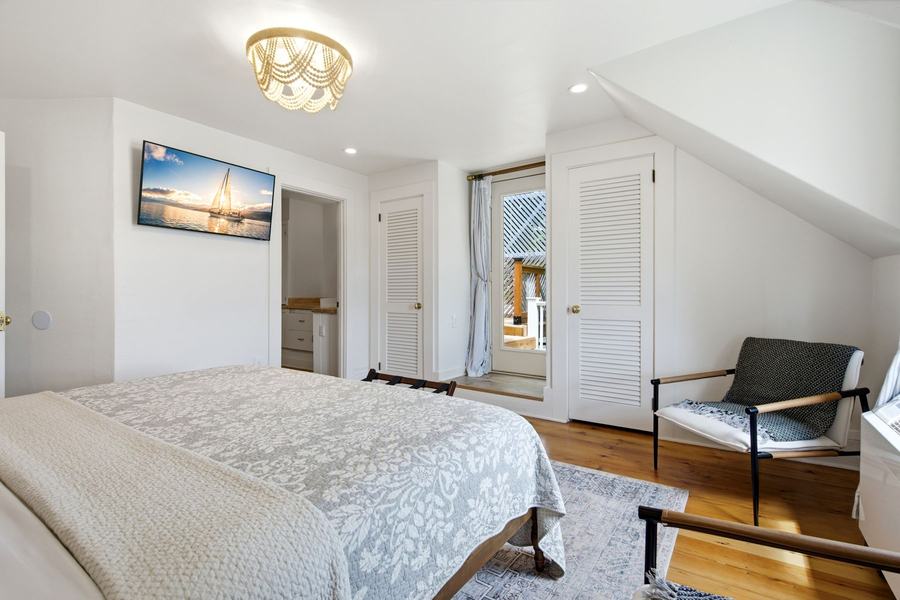 Spacious king suite with a sitting area, TV, and access to a private balcony.
